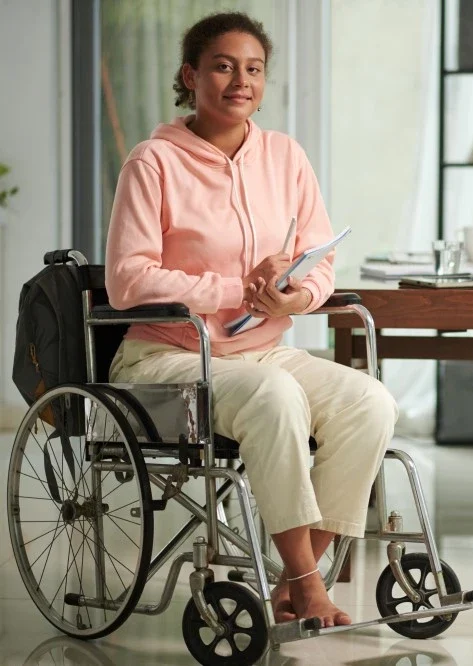 Disabled woman in wheelchair smiling at the camera